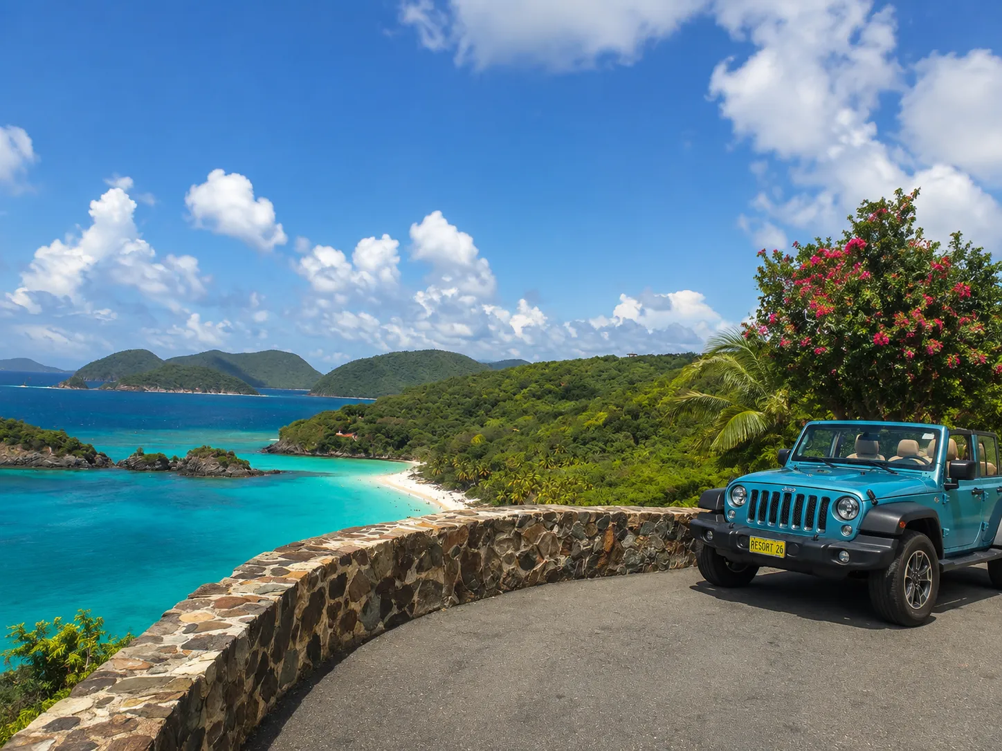 A rental Jeep parked at a stone-wall overlook above St. John, turquoise Trunk Bay and forested hills visible below